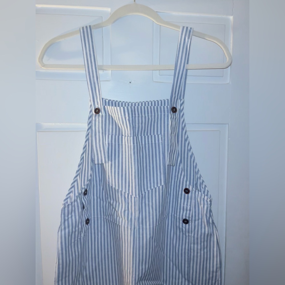 Women’s blue and white striped overalls. New with tags. Size: Small.